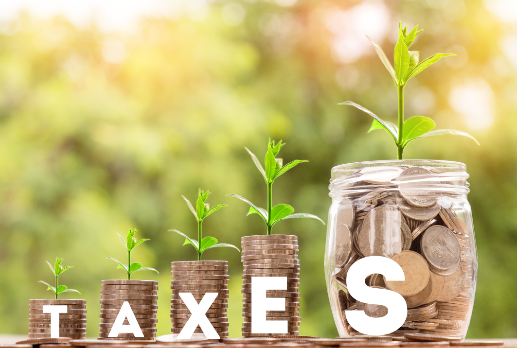 Stack of coins in jars increasing in size, symbolizing tax savings and financial growth.